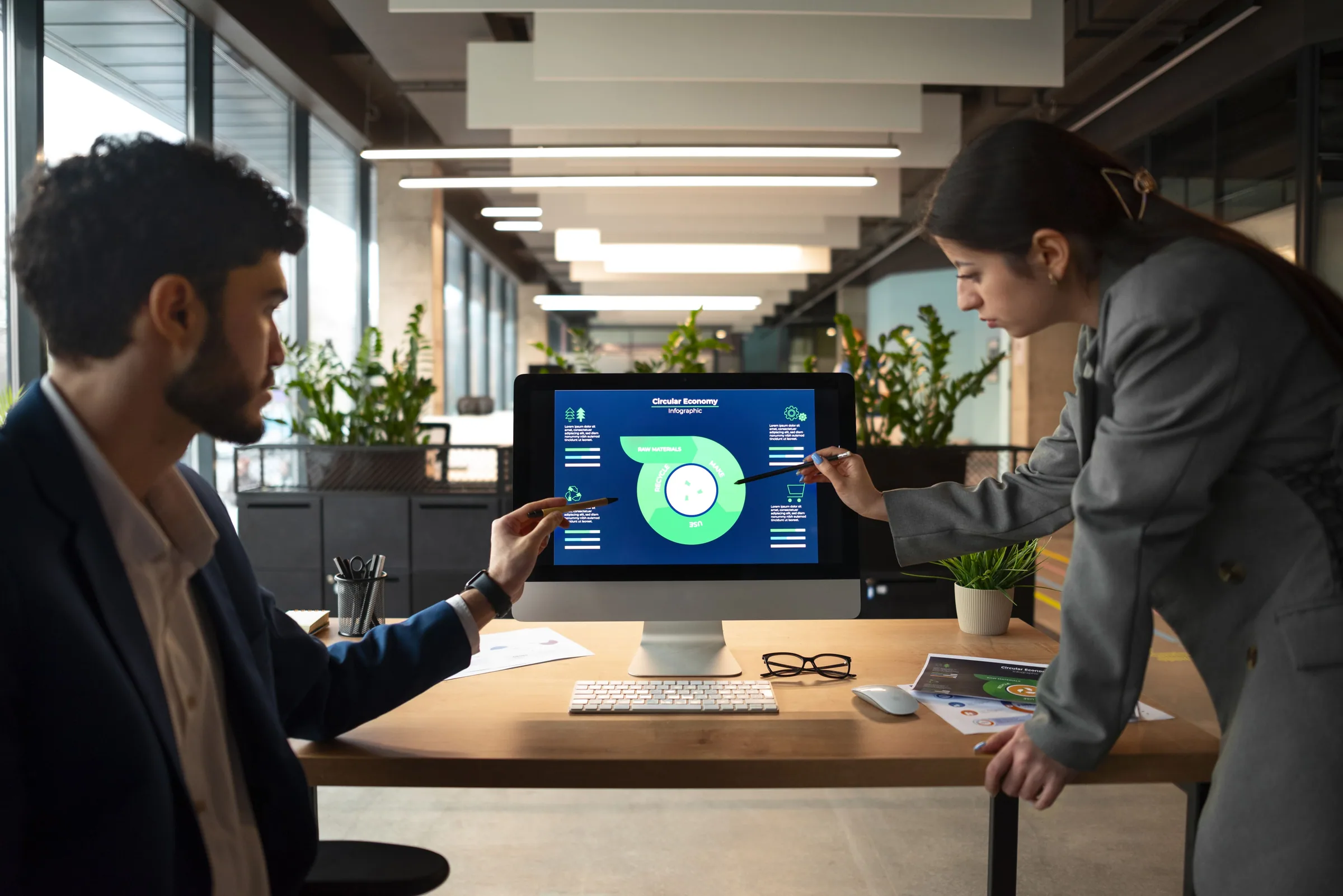 Business professionals discussing a centralized error management system on a desktop screen.